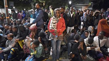 Migrants gather and wait before being evacuated from a makeshift migrant camp set up between the metro stations of Jaures and Stalingrad, in Paris, on September 16, 2016. (AFP)