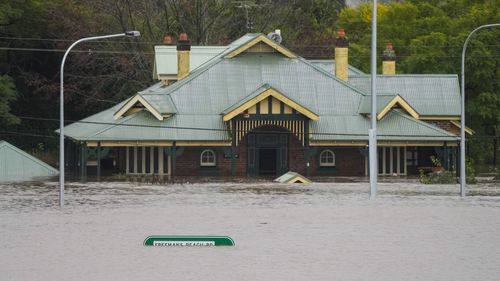 A building is inundated with water on the far side of the Windsor Bridge at Windsor on the outskirts of Sydney.