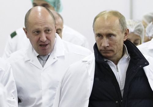 Businessman Yevgeny Prigozhin, left, shows Russian President Vladimir Putin, around his factory which produces school meals, outside St. Petersburg, Russia on Sept. 20, 2010.