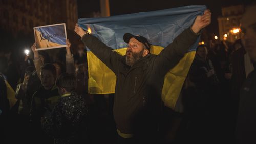Ukrainians gather in central Kyiv to celebrate the recapturing of Kherson city, Ukraine, Friday, November 11, 2022.
