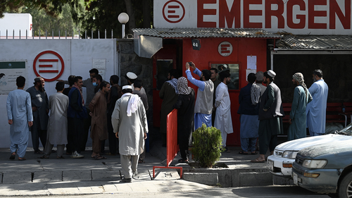People gather to check on missing relatives a day after a twin suicide bombs attack, which killed scores of people including 13 US troops outside Kabul airport, at a hospital run by Italian NGO Emergency in Kabul on August 27, 2021. (Photo by Aamir QURESHI / AFP).