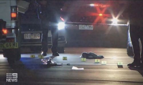 Police mark out evidence at the crime scene of the Point Cook incident.