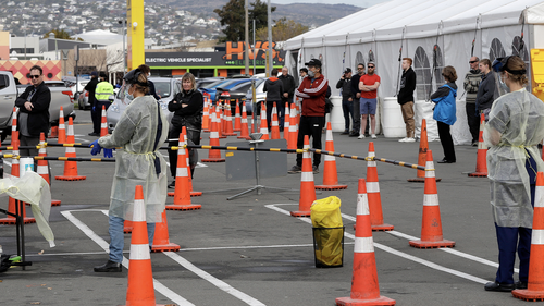 FILE - In this April 17, 2020, file photo, shoppers line up at a pop-up community COVID-19 testing station at a supermarket carpark in Christchurch, New Zealand. (AP Photo/Mark Baker,File)