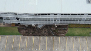 'Unstable' building at risk of collapse after sinkhole opens up