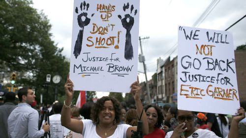 The powerful signs at the protest against police brutality. (Getty Images)