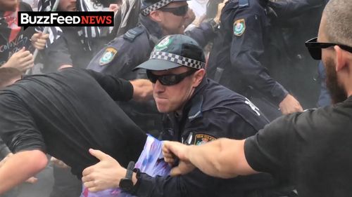 Police tackle a young man. (Image: Buzzfeed News)