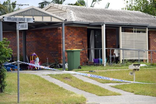 Children's play toys remain in the front yard of an Eagleby home where the bodies of two people were found yesterday (AAP).