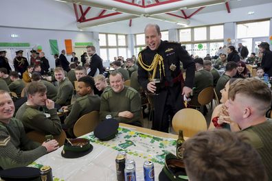 Prince William the Prince of Wales meets with junior ranks of the Irish Guards and their families in the dining hall and enjoys a glass of Guinness during a visit to the 1st Battalion Irish Guards for the St. Patrick's Day Parade at Mons Barracks, in Aldershot, England, Friday, March 17, 2023. 