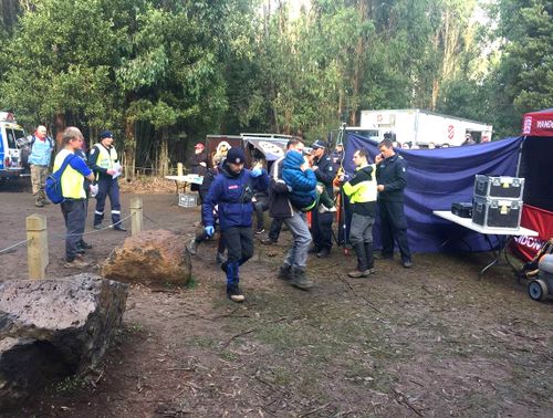 William Callaghan survived two nights of bitterly cold temperatures, wearing just blue tracksuit pants and a hoodie. Here he is seen in a blue jacket, being carried as search party members look on