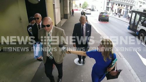 Chris Dawson (far left) arrives at court in Sydney this morning.
