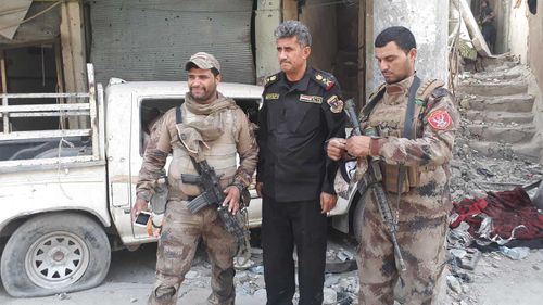 General Abdul Wahab al-Saadi alongside several soldiers. (Owen Holdaway)