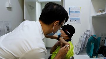 Pharmacist Quinn On gives the AstraZeneca COVID-19 vaccine to Van Nguyen Huong at Cabramatta Priceline.