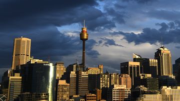 Clouds gather over the Sydney CBD skyline. Workers are expected to return to the office in greater numbers over the coming weeks.