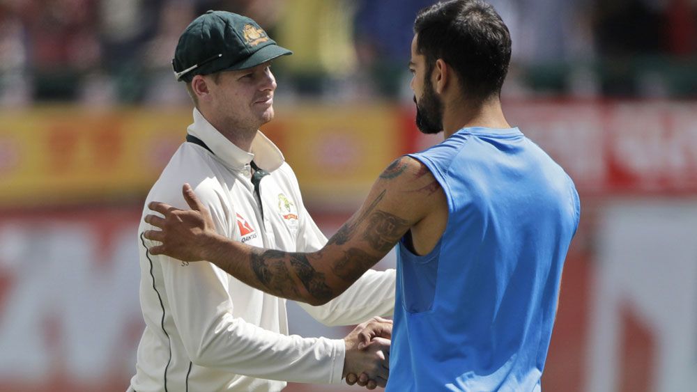 Australia's Steve Smith shakes hands with India's Virat Kohli after Test series loss