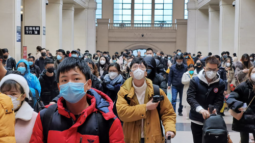 People wear face masks as they wait at Hankou Railway Station on January 22, 2020 in Wuhan, China. 