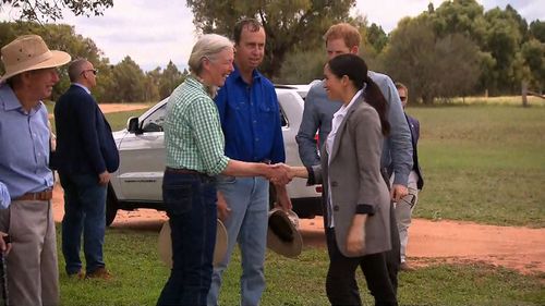 Meghan shakes hands with Elaine Woodley.