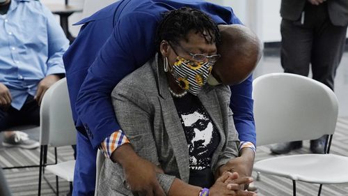 Jimmy Lawson, a friend of Julius Jones, hugs Madeline Davis-Jones, the mother of Julius Jones. 