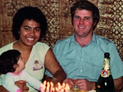 Silva and Ken at home in Australia with one of their daughters.