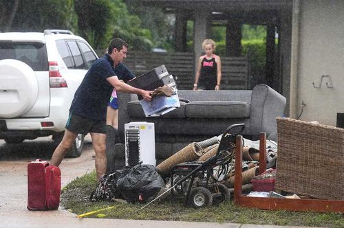 Residents dump furniture ruined by flood waters. 