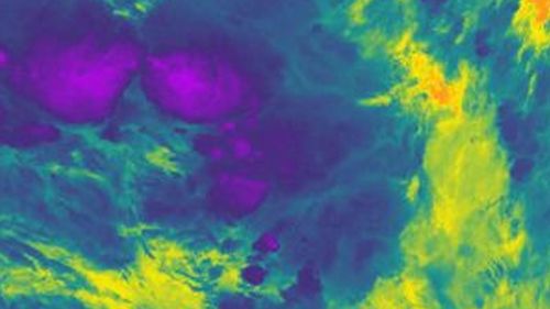 Storms near Nauru on 29 Dec 2018 captured in infrared by an orbiting satellite. The cold parts of the clouds are in purple and the warm Pacific Ocean is in orange.