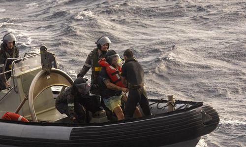 HMAS Choules rescues a solo rowboat adventurer off the east Australian coast.