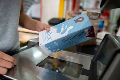 Close-up on a cashier scanning products at the supermarket - business concepts