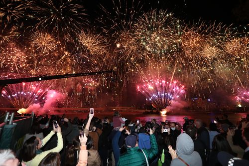 People celebrate in Brisbane following a vote announcement by the International Olympic Committee (IOC) on Brisbane's successfull 2032 Summer Olympics bid, in Brisbane, Wednesday , July 21 , 2021. (AAP Image/Jason O'Brien) NO ARCHIVING