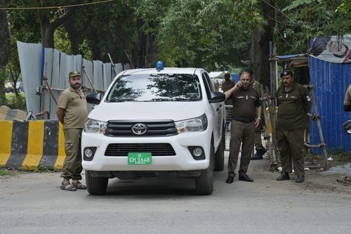 Police officers stand guard outside the residence of Pakistan's former Prime Minister Imran Khan, in Lahore, Pakistan, Saturday, Aug. 5, 2023. 