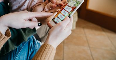 Mother using phone at home