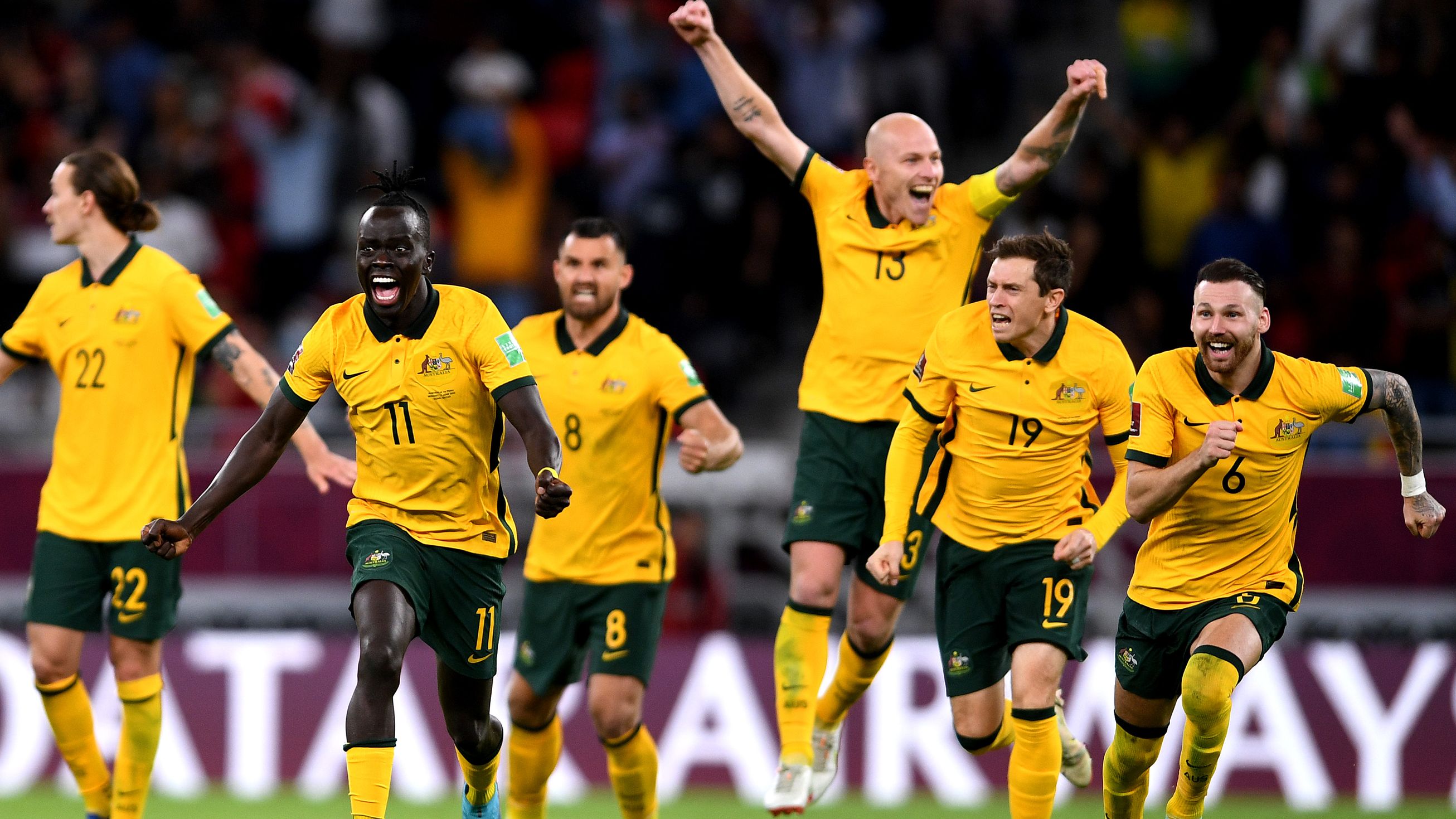 The Socceroos celebrate after defeating Peru in the 2022 FIFA World Cup playoff match at Ahmad Bin Ali Stadium.