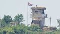 A North Korean soldier stands at the North&#x27;s military guard post as a North Korean flag flutters in the wind, seen from Paju, South Korea, on June 26, 2024.