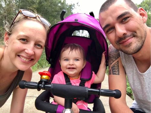 Volunteer firefighter Andrew O'Dwyer with his partner Mel with their young daughter Charlotte. (Facebook)