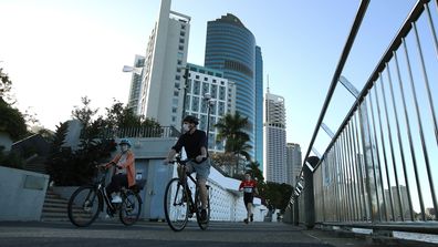 People walking near the Brisbane CBD after lockdown began on July 31, 2021 in Brisbane.