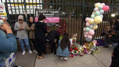 Members of the community observed a minute of silence at the vigil. (9NEWS)