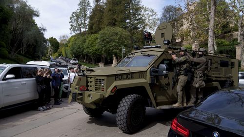 A law enforcement vehicle rumbles up to a a Beverly Hills property belonging to Sean 'Diddy' Combs.