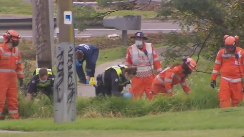 Police and SES search the grounds of nearby carparks for signs of a weapon.