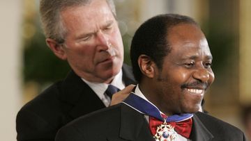 President Bush awards Paul Rusesabagina, who sheltered people at a hotel he managed during the 1994 Rwandan genocide, the Presidential Medal of Freedom Award in the East Room of the White House, in Washington (Photo: Nov, 2005)
