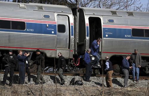 The GOP lawmakers helped passengers off the train after the crash. (AAP)