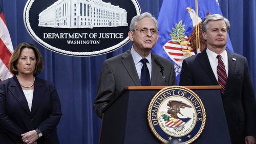 Attorney General Merrick Garland, centre, flanked by Deputy Attorney General Lisa Monaco, left, and FBI Director Christopher Wray, speaks to reporters as they announce charges against two men suspected of being Chinese intelligence officers for attempting to obstruct a US criminal investigation and prosecution of Chinese tech giant Huawei.