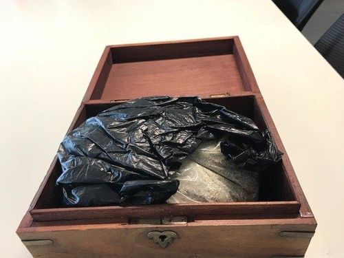 Police believe the ashes inside the box belong to a human.