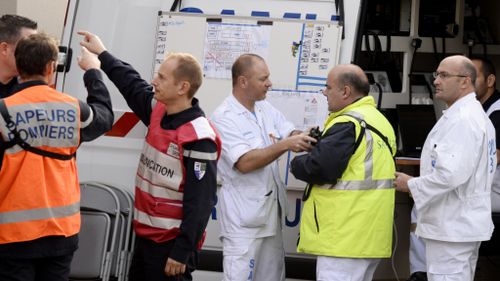 Emergency workers treat crash victims. (AFP)
