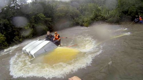 Trio rescued from car in NSW floodwaters