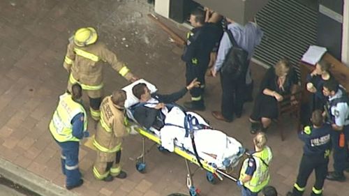 One man was taken from the scene by paramedics on a stretcher. (9NEWS)