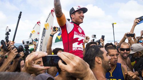 Fans surround Gabriel Medina after his earlier, spectacular score. (Getty)