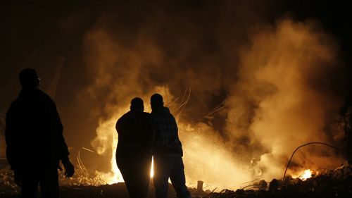 Palestinian residents try to put out a fire that blazed up after an assault by the Israeli military during Operation Pillar of Defence. (Getty)
