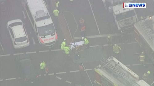 A person is taken away in a stretcher. (9NEWS)