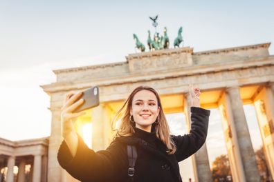 young woman taking selfie, Berlin, Brandenburg Gate Berlin, Germany