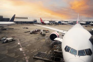 Airplane parked at the airport at sunrise