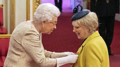 Queen Elizabeth II wears gloves as she awards the CBE actress Wendy Craig, during an investiture ceremony.