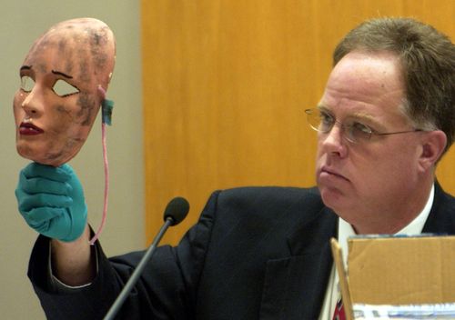 Wichita Police Detective Sam Houston shows a mask, which was used in one of the crimes, during Dennis Rader's 2005 sentencing hearing in Wichita, Kansas. Rader of Park City, Kansas pleaded guilty to the 10 killings dating back to 1974. 